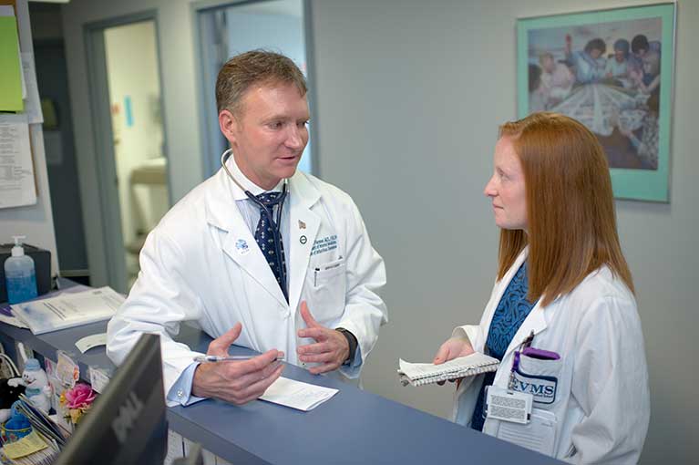 Dr. Flenner speaks with a student