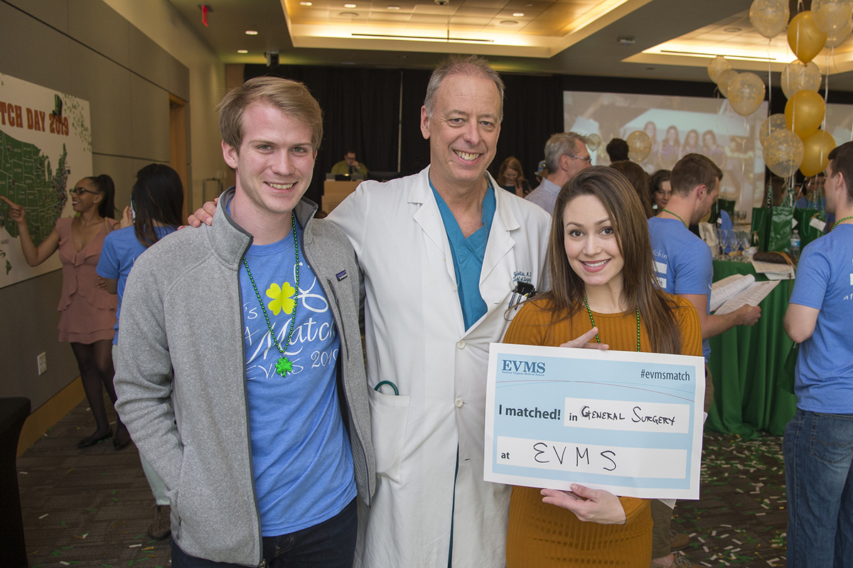 A fourth-year EVMS medical student stands with doctor in white coat.