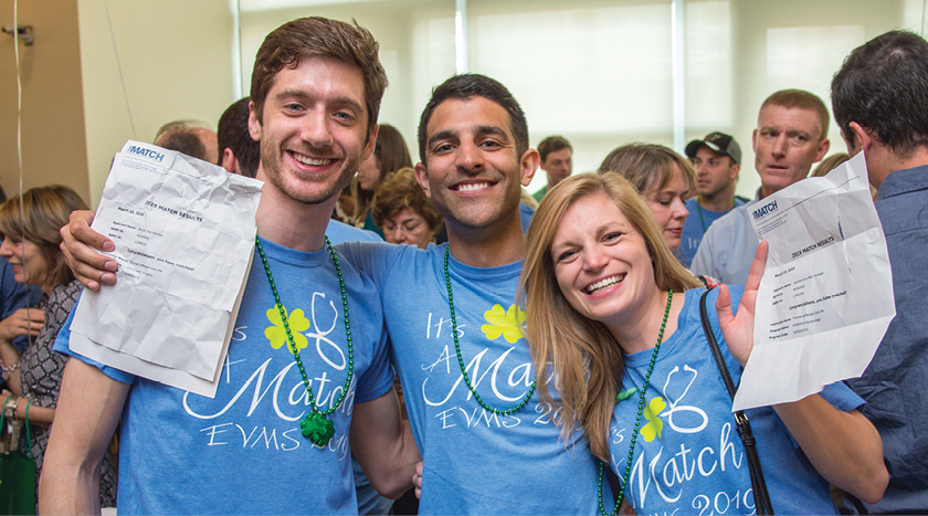 Three fourth-year EVMS medical students celebrating with their Match Day letters.