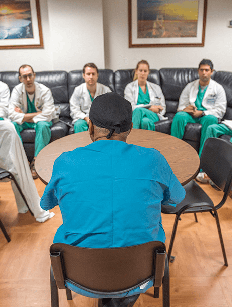 Dr. Britt lectures a group of EVMS students sitting around a table