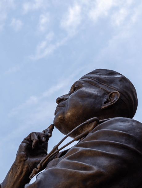 Statue of Dr. Britt against a bright blue sky