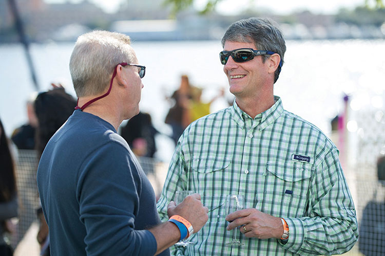 Todd Palmerton MD (MD ’85), and F. Taylor Wootton III, MD (MD ’85) caught up with each other during Alumni Weekend at the EVMS Alumni Chalet at the Town Point Virginia Wine Festival.