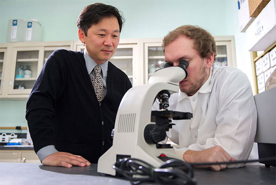 Woong-Ki Kim, MD and Adam Filipowicz in the lab