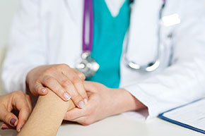 Doctor taking a patient's hand