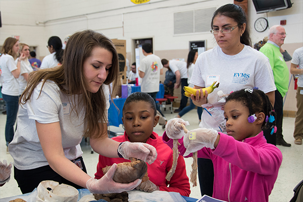 EVMS students giving Tidewater Park Elementary School students some hands-on experience.