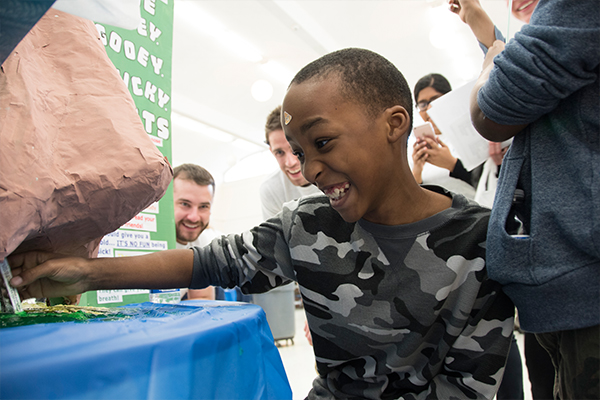 A young student uses a model nose to understand it's contents.