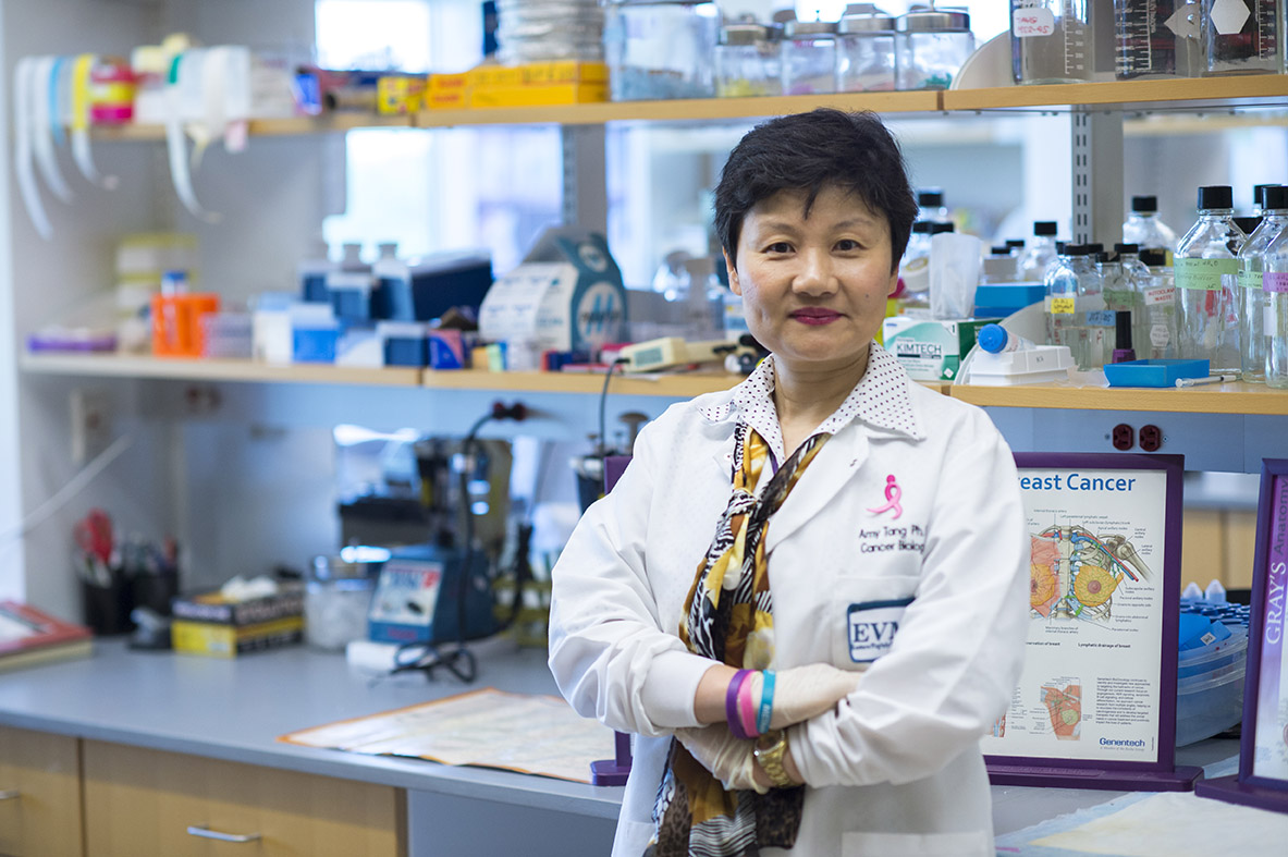 Dr. Tang standing in her Mircrobiology and Molecular Cell Biology Lab