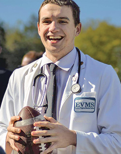 Second-year medical student, David Neuberger, holding a football.