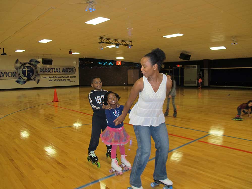 Dr. Salkey pulls her children behind her as she skates.